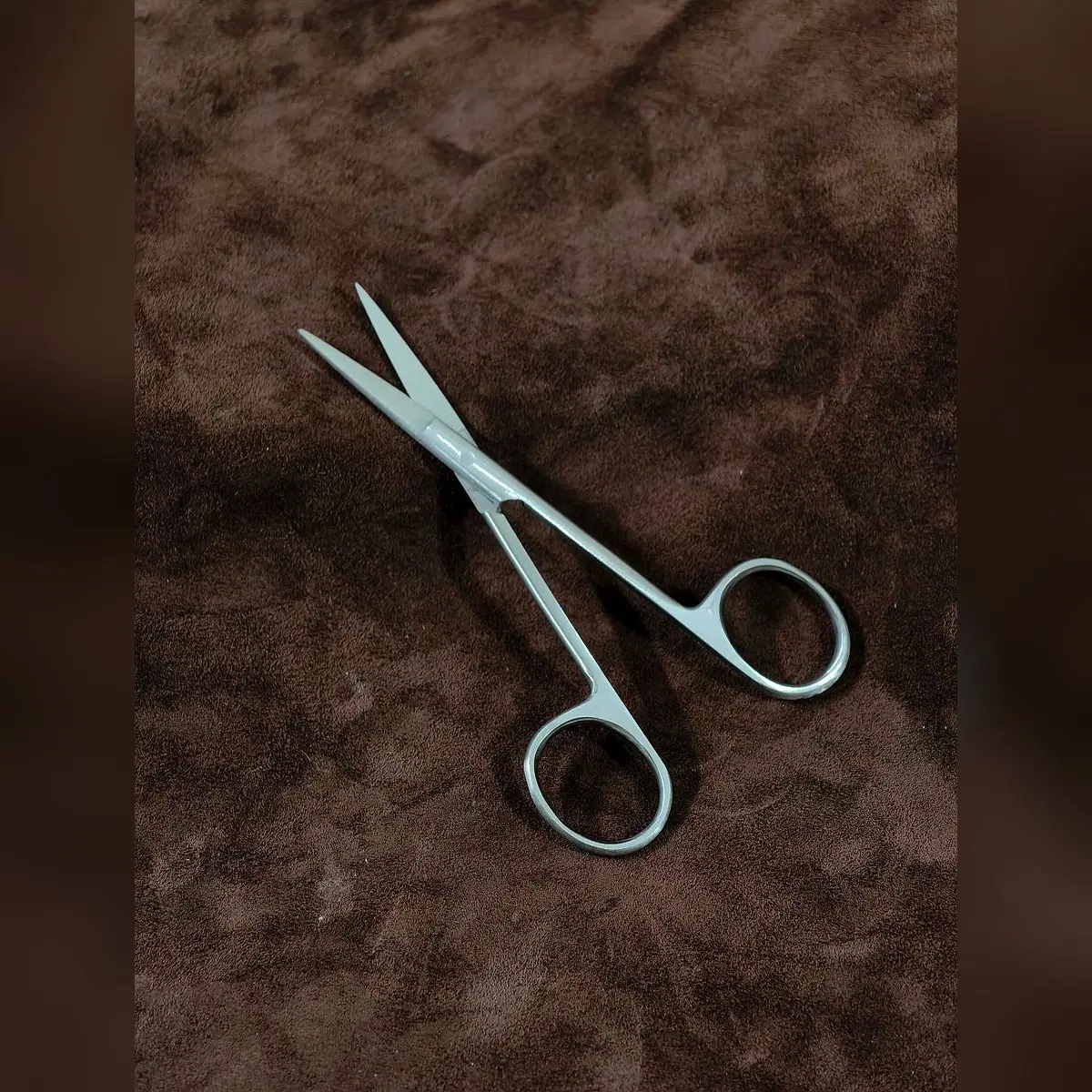 Iris Scissors Round, Single-Use by Morbella Instruments — blades open, diagonal, photographed at the Sialkot workshop