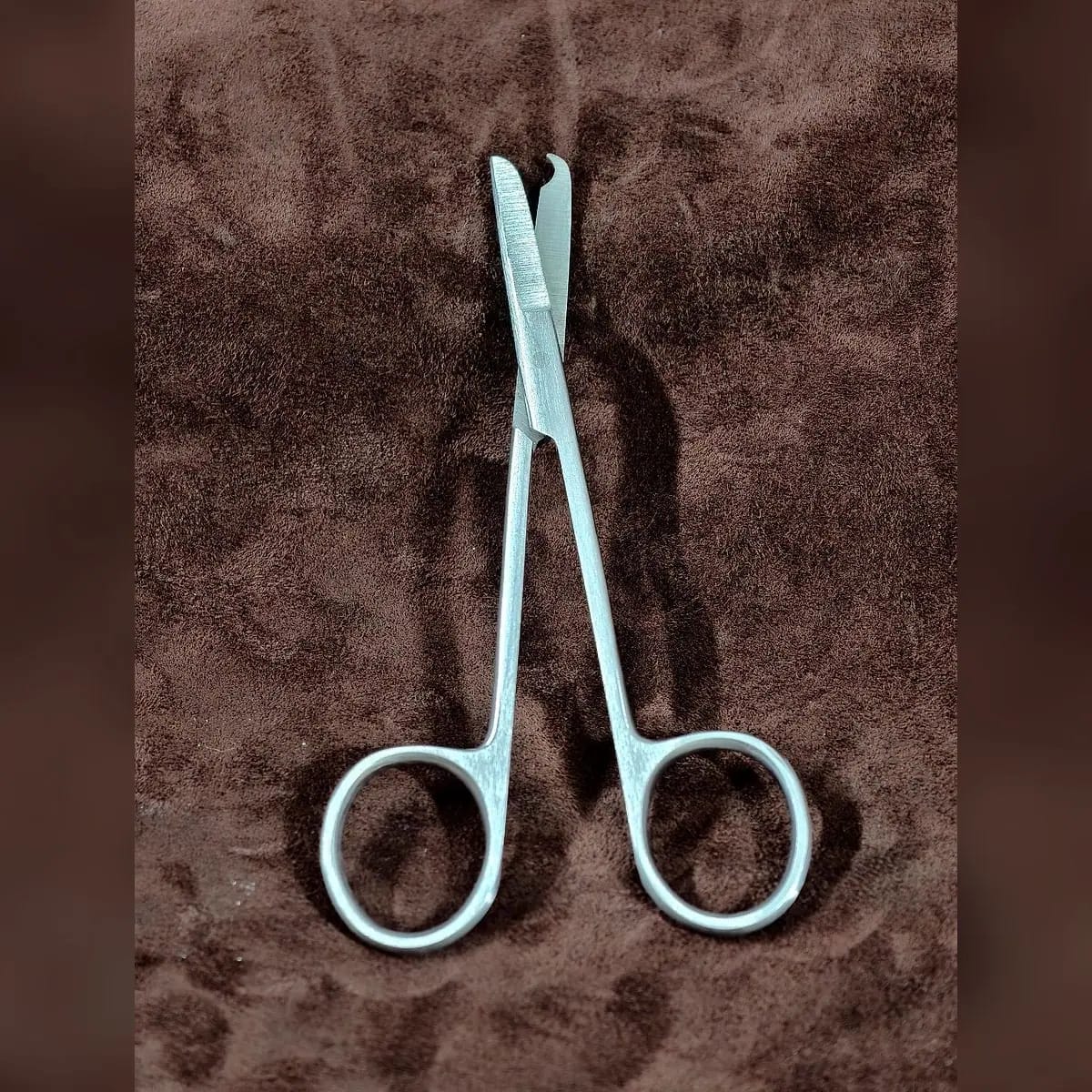 Stitch Scissors, Single-Use by Morbella Instruments — blades open, diagonal, photographed at the Sialkot workshop